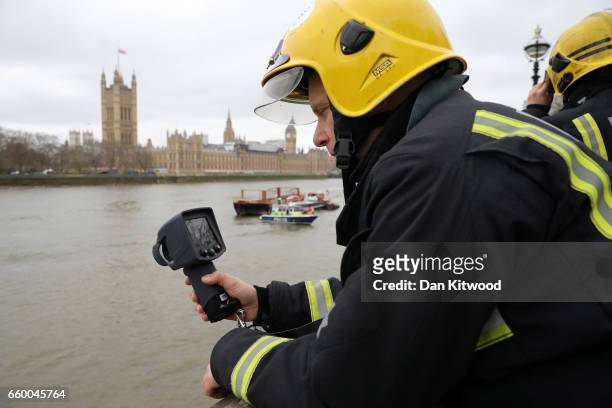 Emergency services look for a person thought to have fallen from Westminster Bridge into the River Thames on March 29, 2017 in London, England.