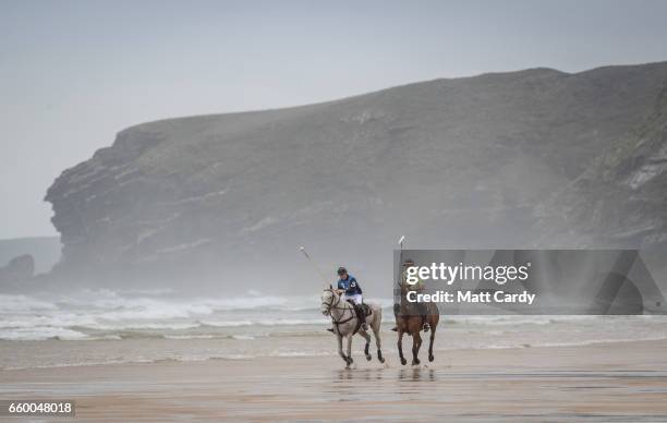 Andy Burgess riding Tonka and Daniel Loe riding La Sofia practice for the forthcoming Aspall Polo on the Beach at Watergate Bay on March 29, 2017 in...