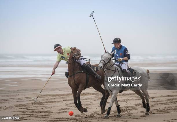 Andy Burgess riding Tonka and Daniel Loe riding La Sofia practice for the forthcoming Aspall Polo on the Beach at Watergate Bay on March 29, 2017 in...