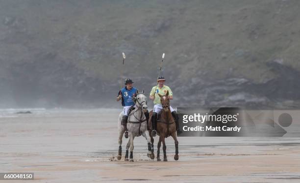 Andy Burgess riding Tonka and Daniel Loe riding La Sofia practice for the forthcoming Aspall Polo on the Beach at Watergate Bay on March 29, 2017 in...
