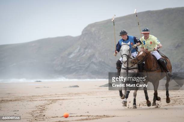 Andy Burgess riding Tonka and Daniel Loe riding La Sofia practice for the forthcoming Aspall Polo on the Beach at Watergate Bay on March 29, 2017 in...