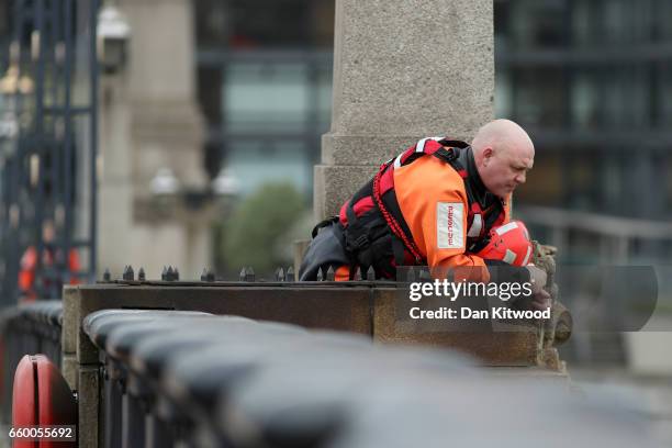 Member of the Emergency service looks for a person thought to have fallen from Westminster Bridge into the River Thames on March 29, 2017 in London,...