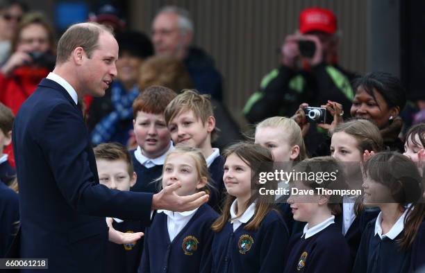 Prince William, Duke of Cambridge meets pupils from All Saints School in Alrewas during the official opening of a new Remembrance Centre at The...