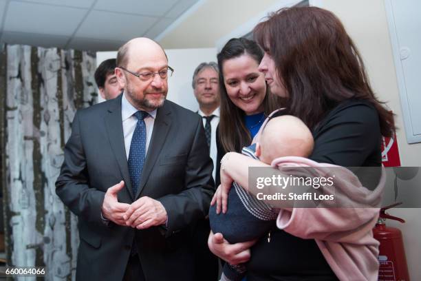 Martin Schulz, chairman of the Social Democratic Party of Germany , speaks with parents of newborn children during a visit to the multi-generational...