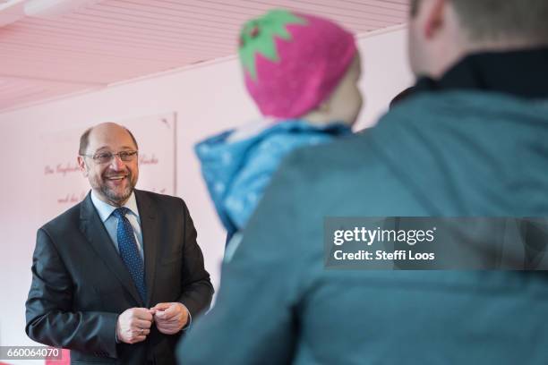 Martin Schulz, chairman of the Social Democratic Party of Germany , speaks with parents of newborn children during a visit to the multi-generational...