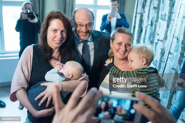 Martin Schulz, chairman of the Social Democratic Party of Germany , poses with mothers during a visit to the multi-generational house Philantow on...