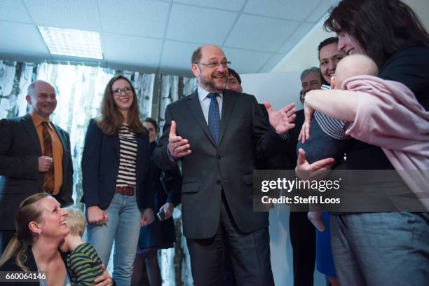 Martin Schulz, chairman of the Social Democratic Party of Germany , speaks with parents of newborn children during a visit to the multi-generational...