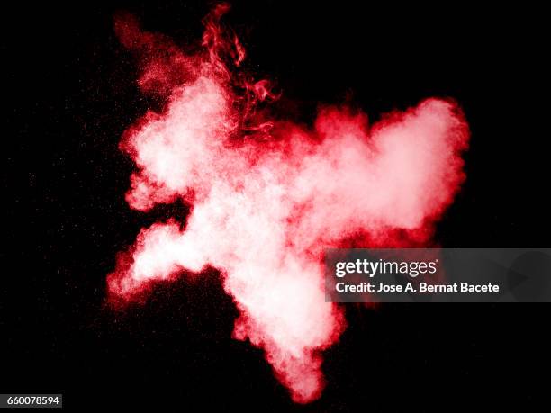 explosion of a cloud of powder of particles of white color on a black background - etéreo stockfoto's en -beelden