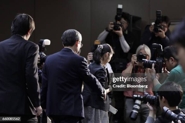 Satoshi Tsunakawa, president of Toshiba Corp., exits past photographers following a news conference in Tokyo, Japan, on Wednesday, March 29, 2017....