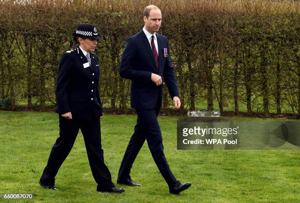 Prince William, Duke of Cambridge walks with Staffordshire Police Chief Constable Jane Sawyers, after laying a wreath at the Police memorial at The...