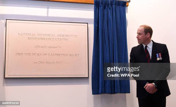 Prince William, Duke of Cambridge unveils a plaque at the The National Memorial Arboretum after opening the new visitors centre on March 29, 2017 in...