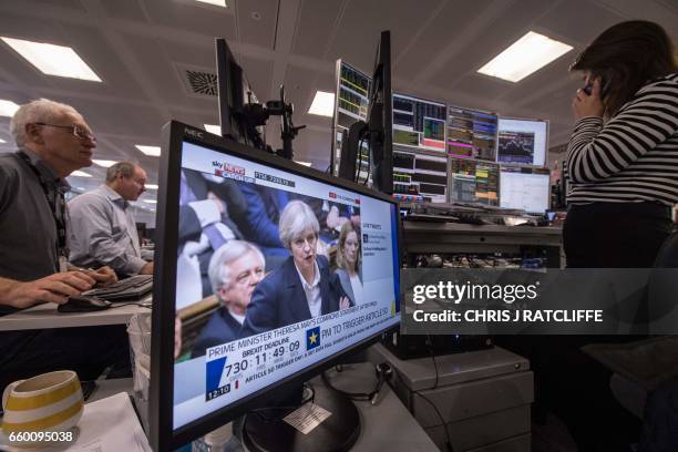 Television screen displays an image of British Prime Minister Theresa May as she speaks during Prime Minister's Questions in the Houses of Parliament...