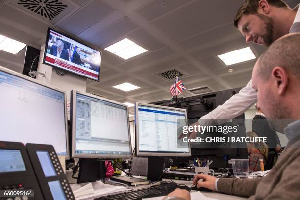 Television screen displays an image of British Prime Minister Theresa May as she speaks during Prime Minister's Questions in the Houses of Parliament...