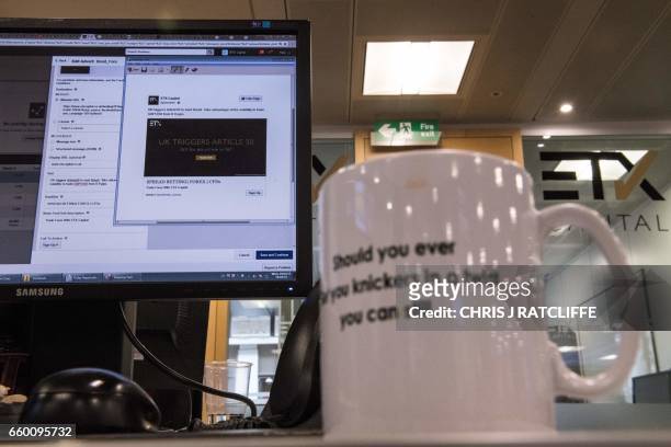 Mag is pictured on a trader's desk as a note on their screen is prepared to alert clients that the British government have triggered Article 50 of...