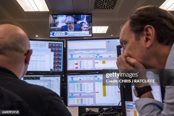 Television screen displays an image of British Prime Minister Theresa May as she speaks during Prime Minister's Questions in the Houses of...