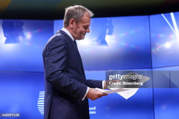 Donald Tusk, president of the European Union , holds the letter invoking Article 50 of the Lisbon Treaty from U.K. Prime Minister Theresa May as...