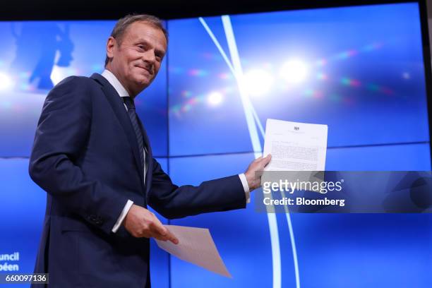 Donald Tusk, president of the European Union , holds the letter invoking Article 50 of the Lisbon Treaty from U.K. Prime Minister Theresa May as...