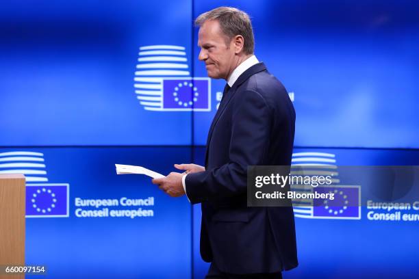 Donald Tusk, president of the European Union , holds the letter invoking Article 50 of the Lisbon Treaty from U.K. Prime Minister Theresa May as he...