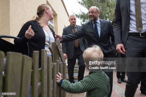 Martin Schulz, chairman of the Social Democratic Party of Germany , greets two-year-old Fredrik and his mother as he leaves the multi-generational...