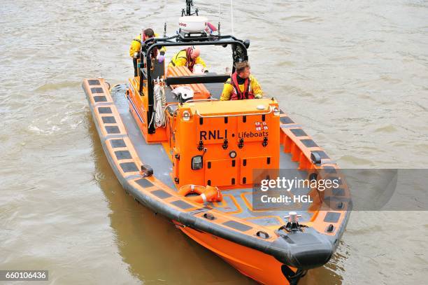 Crew from the Tower Lifeboat station pull a person from the River Thames beneath Westminster Bridge on March 29, 2017 in London, England.