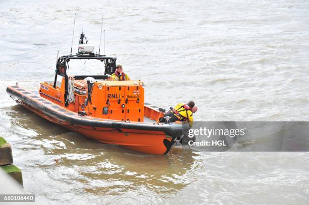 Crew from the Tower Lifeboat station pull a person from the River Thames beneath Westminster Bridge on March 29, 2017 in London, England.