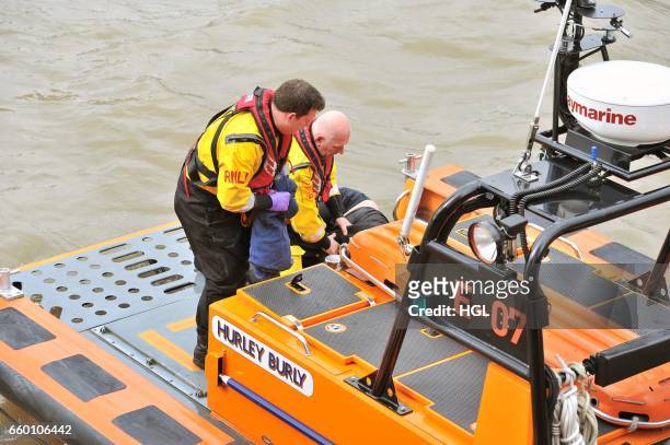 Crew from the Tower Lifeboat station pull a person from the River Thames beneath Westminster Bridge on March 29, 2017 in London, England.