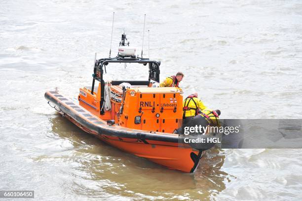 Crew from the Tower Lifeboat station pull a person from the River Thames beneath Westminster Bridge on March 29, 2017 in London, England.