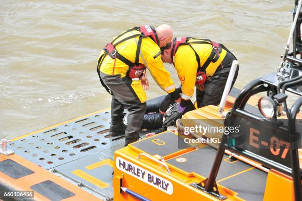 Crew from the Tower Lifeboat station pull a person from the River Thames beneath Westminster Bridge on March 29, 2017 in London, England.