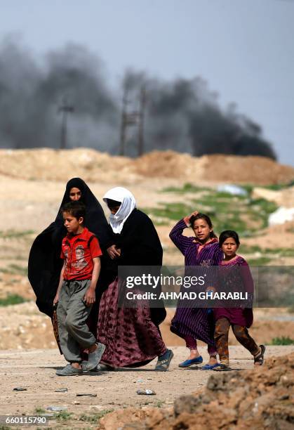 Displaced Iraqis, who fled their homes in the old city of western Mosul due to the ongoing fighting between government forces and Islamic State group...