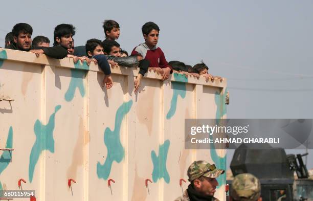 Displaced Iraqis, who fled their homes in the old city of western Mosul due to the ongoing fighting between government forces and Islamic State group...