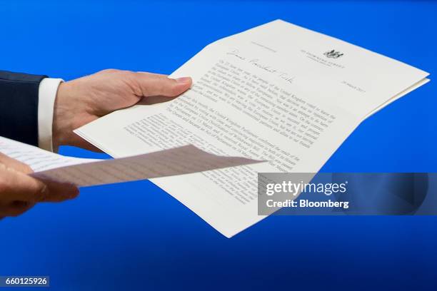 Donald Tusk, president of the European Union , holds the letter invoking Article 50 of the Lisbon Treaty from the U.K. Prime Minister as he leaves a...