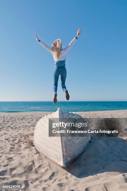 springtime on the beach - solo una donna giovane stock pictures, royalty-free photos & images