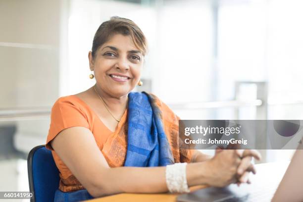 portrait of mature sri lankan woman in office - sari imagens e fotografias de stock