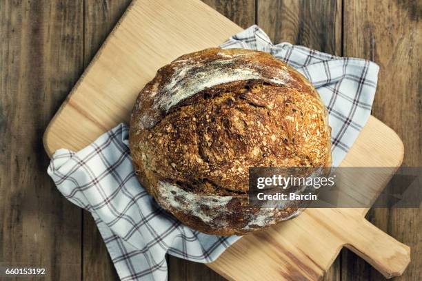 load of bread on cutting board - round loaf stock pictures, royalty-free photos & images