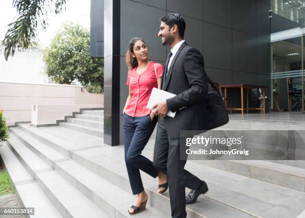 young woman and businessman with tablet on steps - sri lankan ethnicity stock pictures, royalty-free photos & images