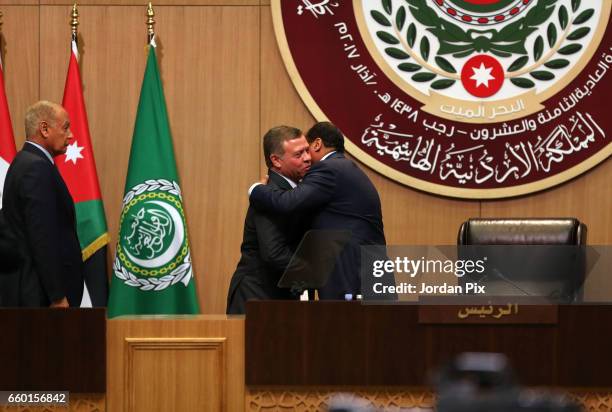 Jordan's King Abdullah II takes on the presidency of the 28th Arab League summit from Mauritanian President Mohamed Ould Abdel Aziz as he is greeted...