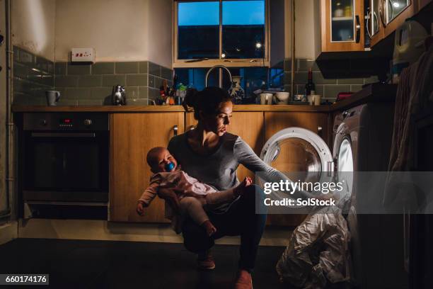 multi-tasking mother - laundry stock pictures, royalty-free photos & images