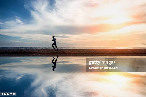 running exercise healthy lifestyle on the summer beach. exercise health concept. - jumping sun bildbanksfoton och bilder