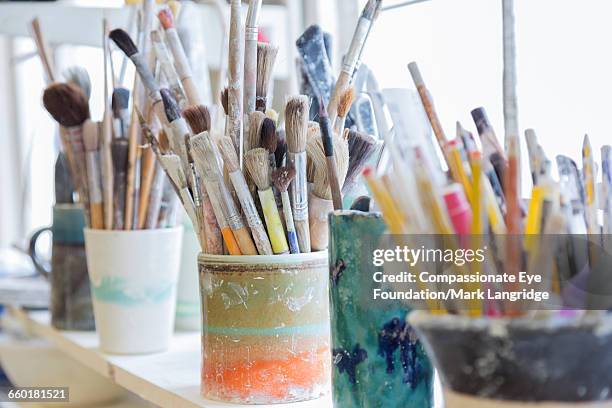 paint brushes in pottery studio - craft supplies stock pictures, royalty-free photos & images