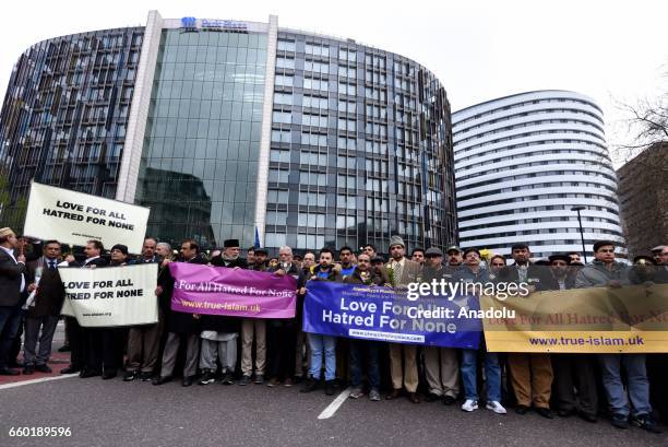 People hold banners reading 'Love for all, hatred for none' on Westminster Bridge ahead of a vigil to remember the victims of last week's Westminster...