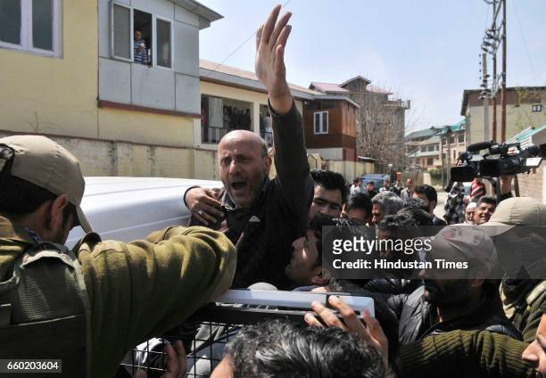 Engineer Rashid , an independent member of the Jammu and Kashmir state assembly and leader of Awami Ittihad Party , shouts slogans as policemen...