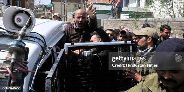 Engineer Rashid , an independent member of the Jammu and Kashmir state assembly and leader of Awami Ittihad Party , shouts slogans as policemen...