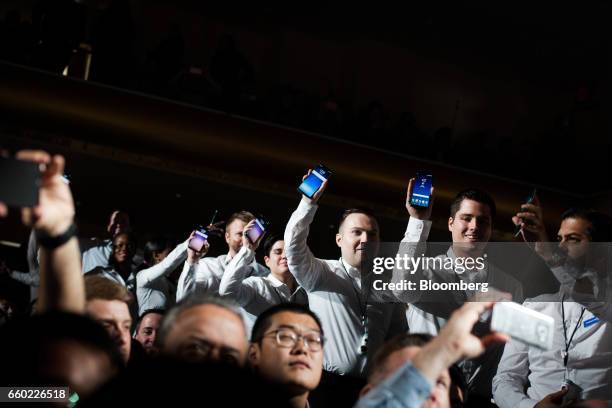 Employees hold up new Samsung Electronics Co. Galaxy S8 smartphones during the Samsung Unpacked product launch event in New York, U.S., on Wednesday,...