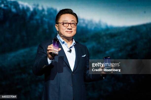 Koh, president of mobile communications business for Samsung Electronics Co., unveils the new Galaxy S8 smartphone during the Samsung Unpacked...