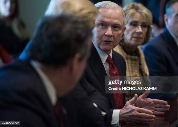 Attorney General Jeff Sessions speaks to President Donald Trump during a meeting about opioid and drug abuse in the Cabinet Room at the White House...