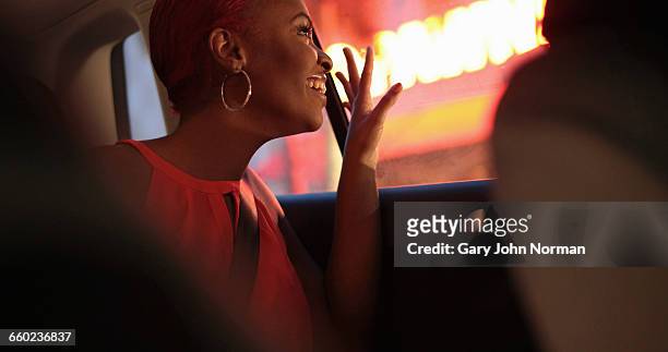 young woman looking out of taxi window at night - west palm beach stock pictures, royalty-free photos & images