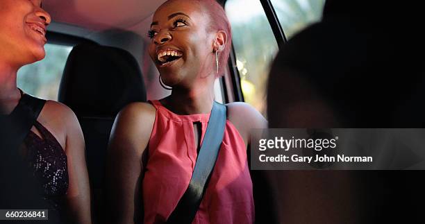 happy friends back of taxi at night - gulf coast stockfoto's en -beelden