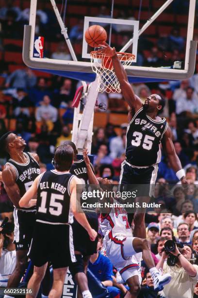 Antoine Carr of the San Antonio Spurs blocks a shot attempt against the New Jersey Nets during a game played circa 1993 at the Brendan Byrne Arena in...