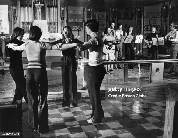 Women dance in front of an altar during a prayer vigil supporting the ordination of women priests in Boston on Feb. 26, 1977. The gathering took...