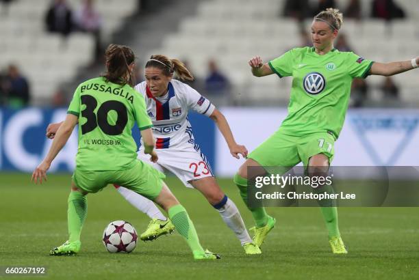 Camille Abily of Olympique Lyon battles with Elise Bussaglia of VFL Wolfsberg and Alexandra Popp of VFL Wolfsberg during the Women's Champions League...
